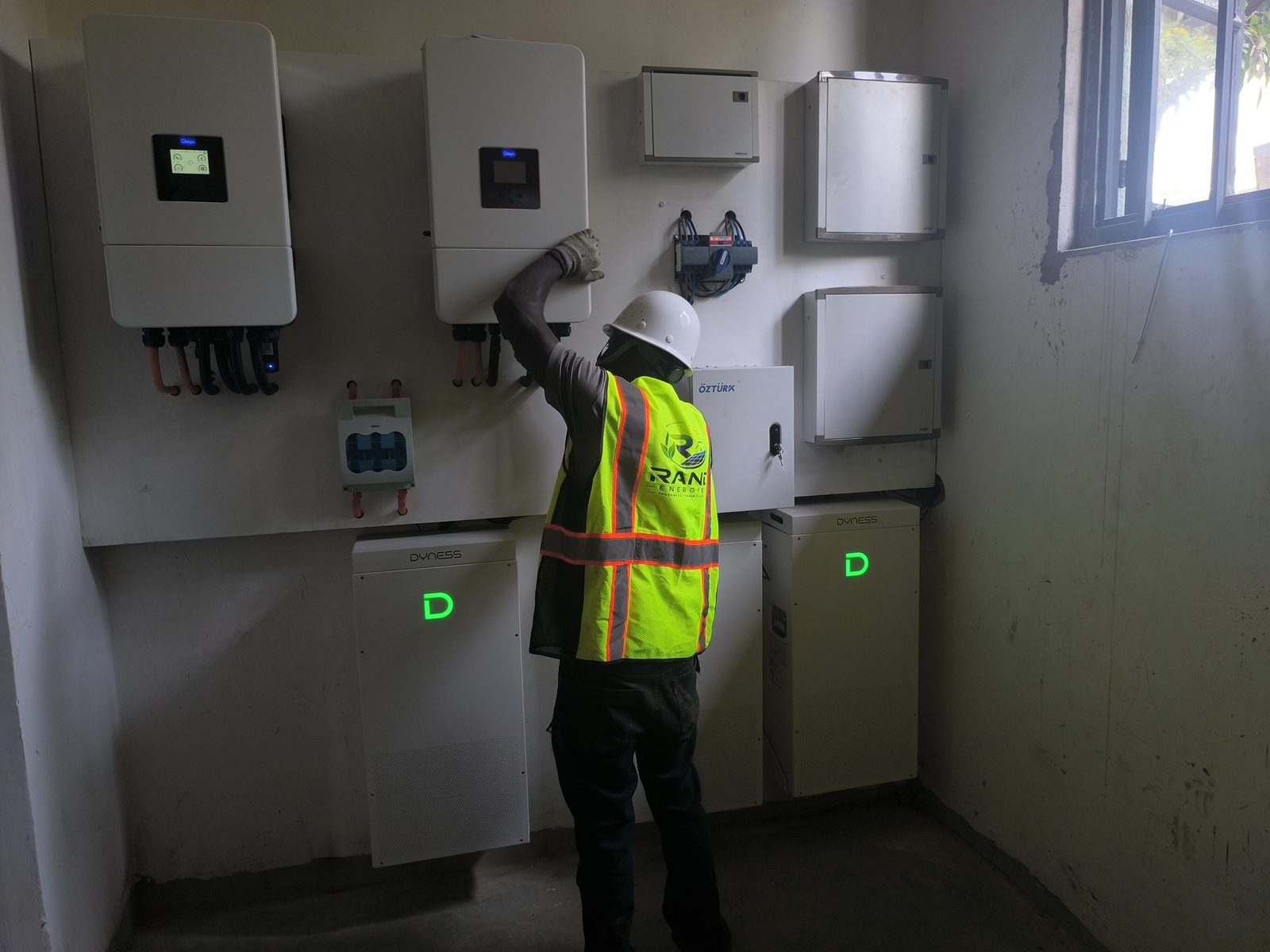 Rand Energies technician commissioning Deye hybrid inverters and Dyness battery storage