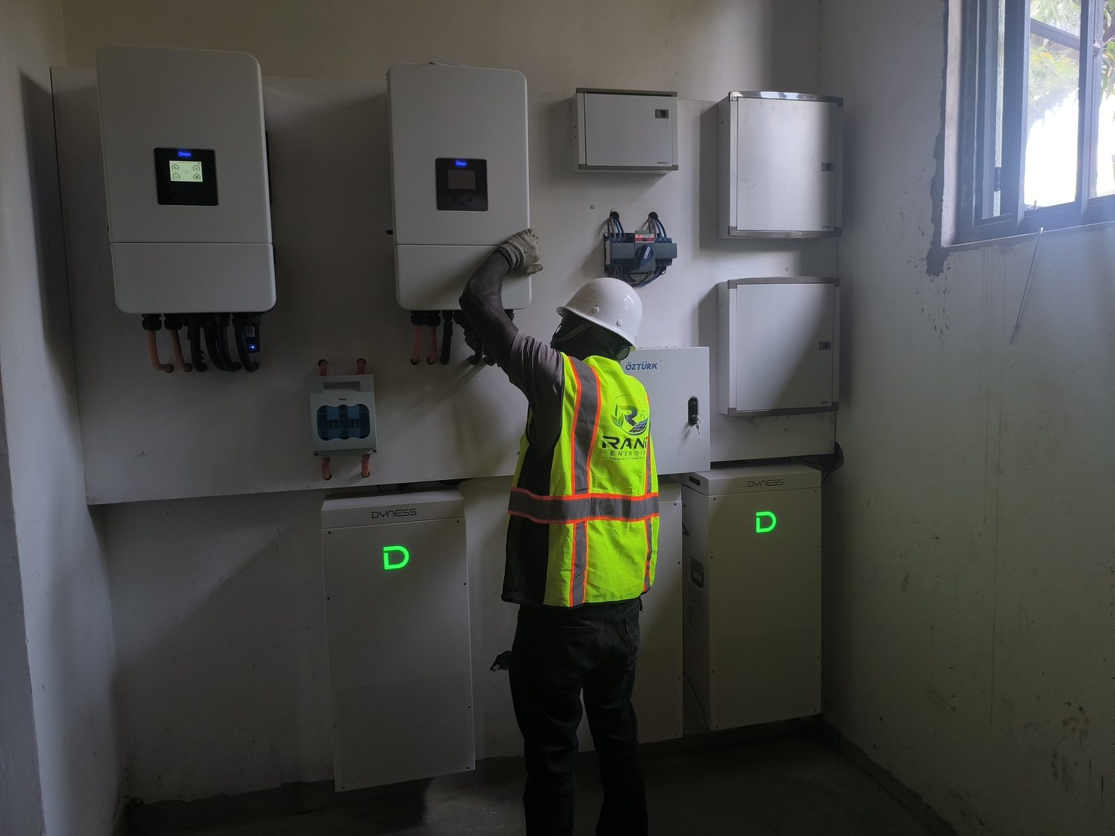 Rand Energies technician commissioning a hybrid inverter on site