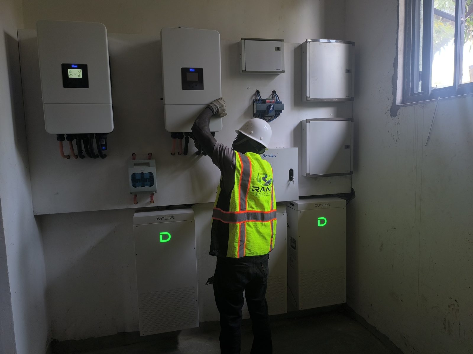 Rand Energies technician commissioning a Deye hybrid inverter